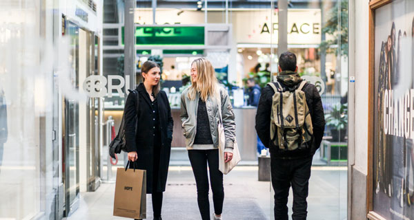 people walking by shops